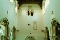 The west wall. Some features of note include the small triangular window halfway up the wall, and the double-headed pair of windows higher up (see closeup in the next photo).