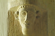 An almost plaintive looking head carved into a nave column, St Mary's, Icomb