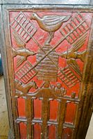 Carved bench end showing a windmill