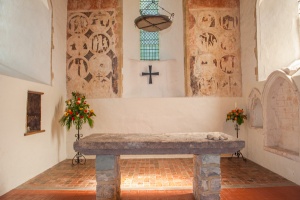 The chancel, stone altar slab, and wall paintings
